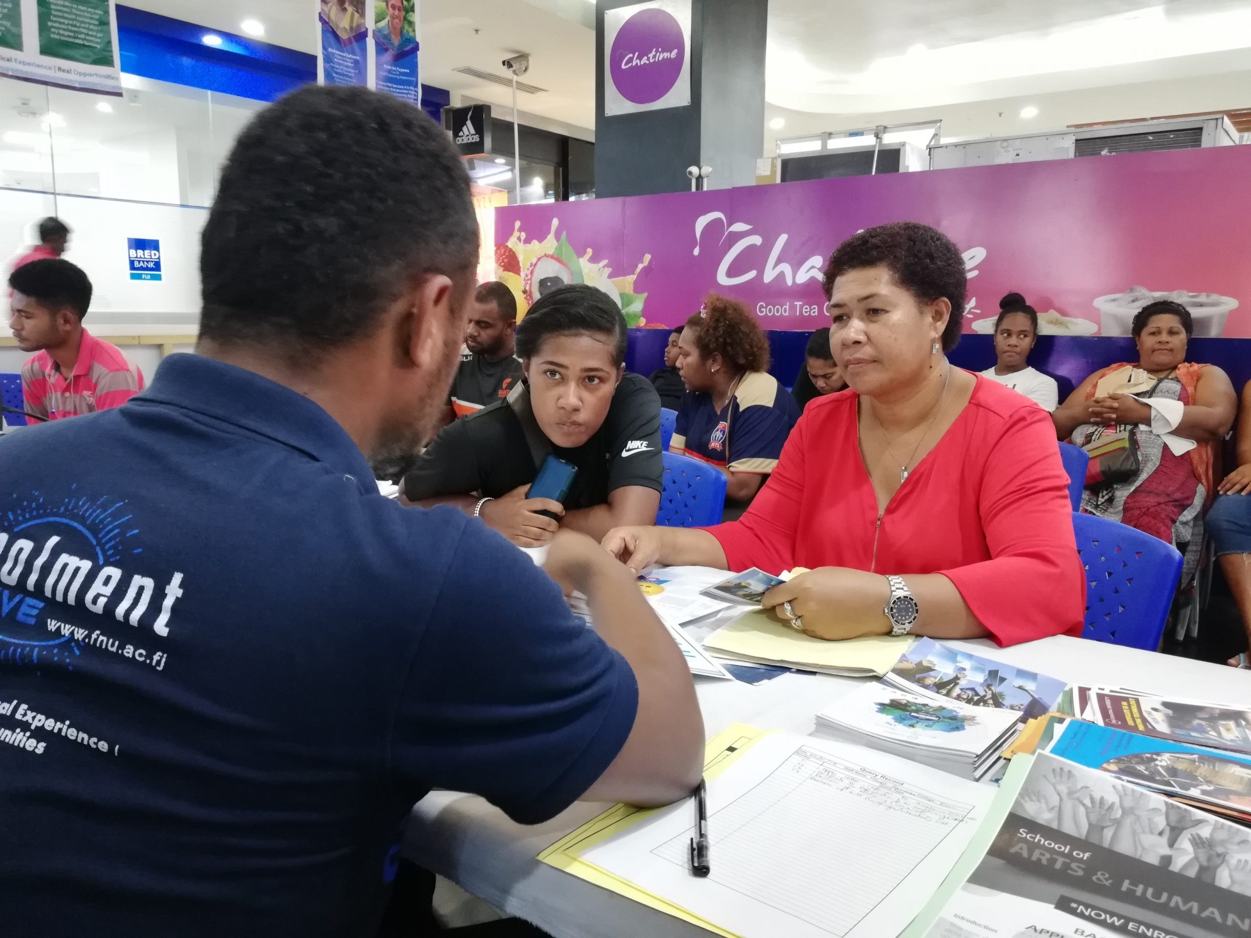 FNU staff assisting students with their enrolment process at MHCC, Suva.