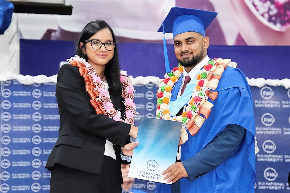Graduate in Bachelor of Engineering (Honours) Civil (Pass) Visham Prasad receives his graduation certificate from Regional CEO - Digicel, Shally Jannif.