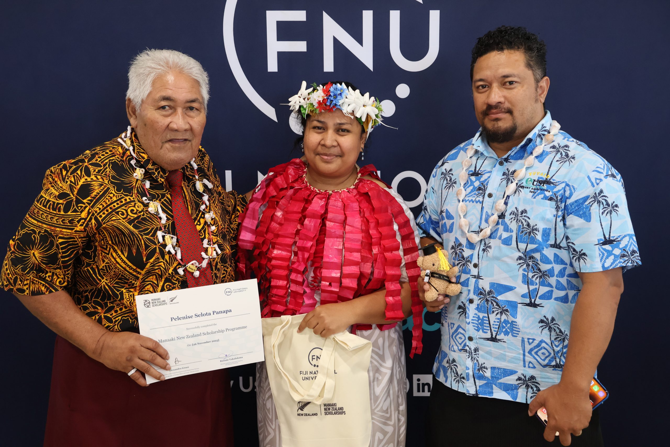 Graduate Pelenise Selota Semilota receives her competition letter during the completion ceremony.