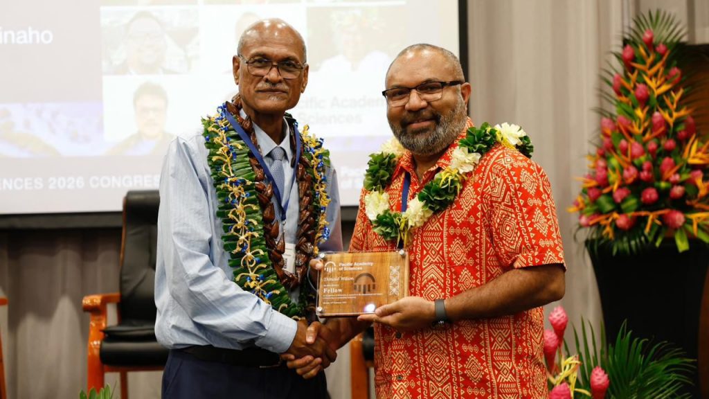 Dr Donald Wilson (right) receiving his fellow plaque from the PAS President Professor Teatulohi Matainaho